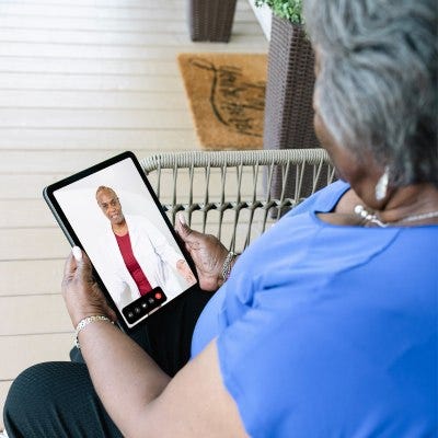 Woman talking to doctor virtually from tablet